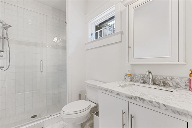 full bathroom featuring vanity, toilet, and a stall shower