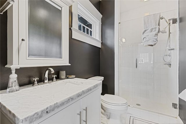 bathroom featuring vanity, toilet, and a stall shower