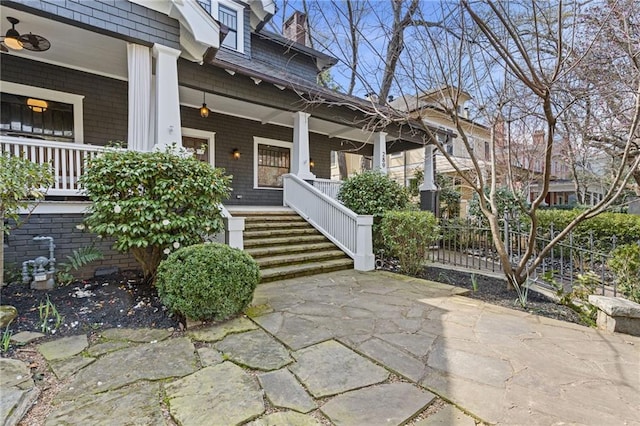 view of exterior entry featuring a porch