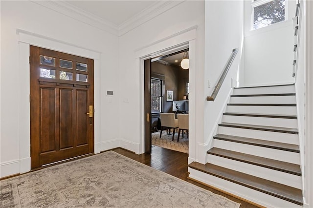 entrance foyer featuring stairway, wood finished floors, baseboards, and ornamental molding