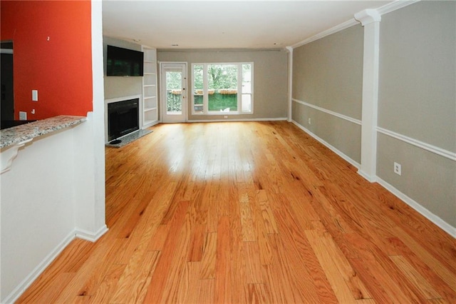 485 Sherman Way, Decatur, GA 30033 - unfurnished living room featuring a fireplace, light wood-style floors, baseboards, and crown molding