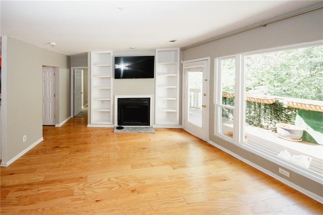 485 Sherman Way, Decatur, GA 30033 - unfurnished living room featuring a fireplace, light wood-type flooring, and baseboards