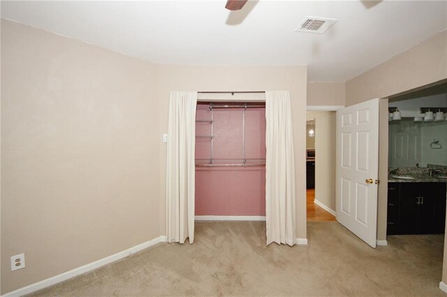 485 Sherman Way, Decatur, GA 30033 - unfurnished bedroom with light carpet, a closet, baseboards, and a ceiling fan