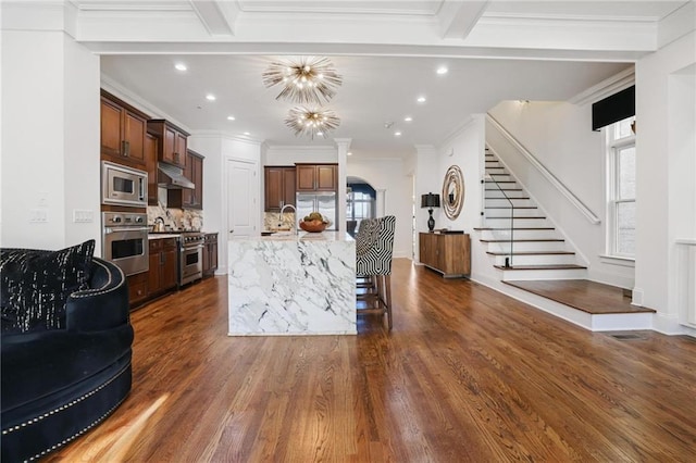 538 Sarabrook Pl NE, Sandy Springs, GA 30342 - kitchen featuring built in appliances, under cabinet range hood, healthy amount of natural light, dark wood-style floors, and recessed lighting