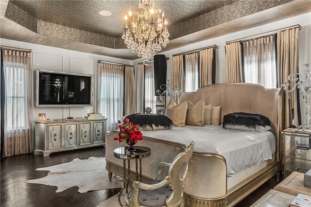 538 Sarabrook Pl NE, Sandy Springs, GA 30342 - bedroom featuring a chandelier, a tray ceiling, and wood finished floors