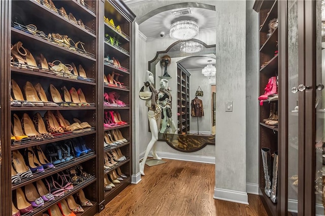 538 Sarabrook Pl NE, Sandy Springs, GA 30342 - spacious closet with arched walkways, a chandelier, and wood finished floors