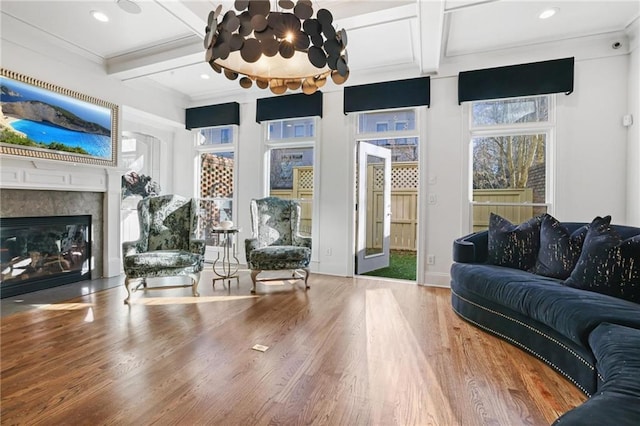 538 Sarabrook Pl NE, Sandy Springs, GA 30342 - living room with coffered ceiling, wood finished floors, a glass covered fireplace, beamed ceiling, and crown molding