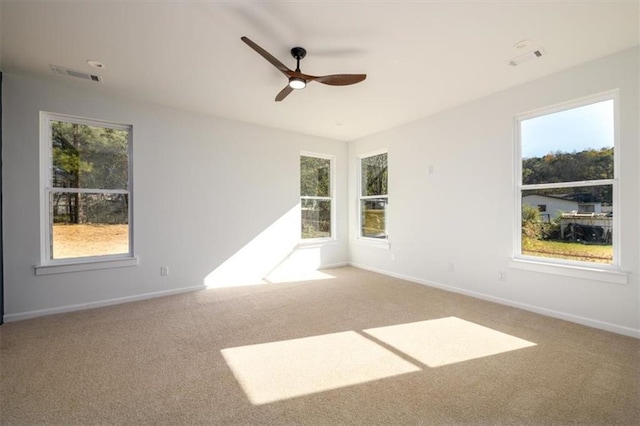 empty room featuring light colored carpet and ceiling fan