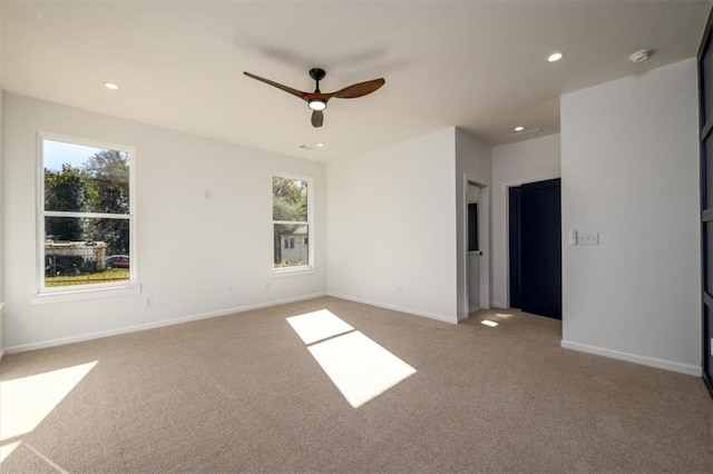 carpeted empty room featuring ceiling fan