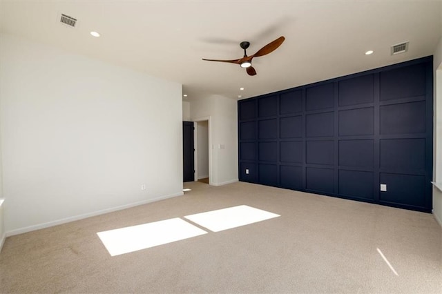 unfurnished bedroom featuring ceiling fan and light carpet