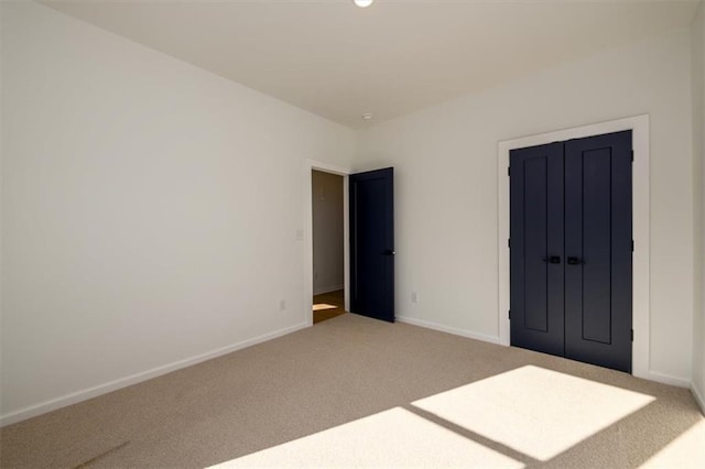 unfurnished bedroom with carpet flooring and a closet