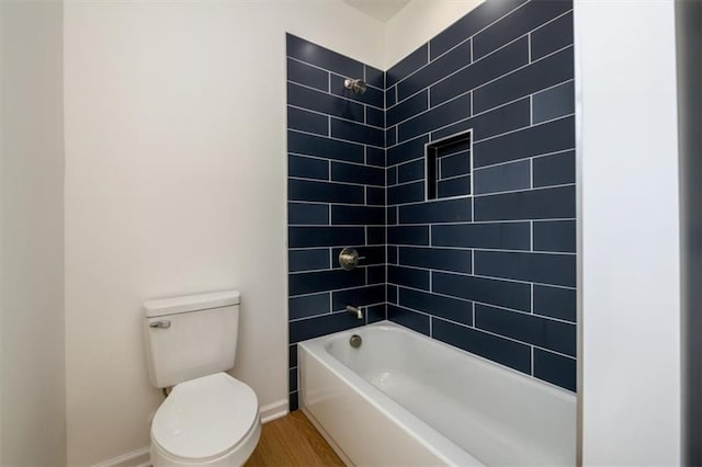 bathroom featuring toilet, tiled shower / bath combo, and hardwood / wood-style flooring