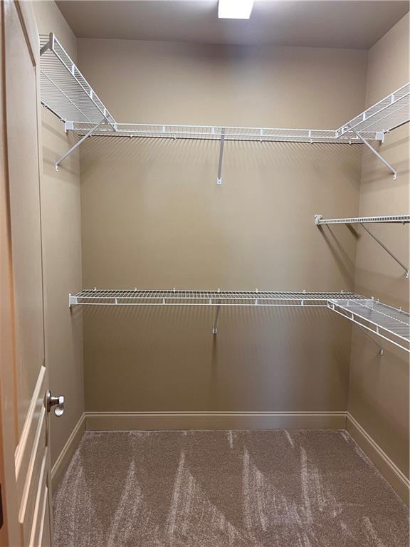 kitchen with stainless steel dishwasher, black refrigerator, sink, and dark wood-type flooring