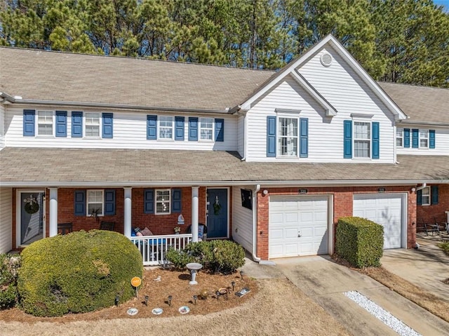 330 Cottonwood Creek Cir, Canton, GA 30114 - view of front of property featuring covered porch, concrete driveway, brick siding, and an attached garage