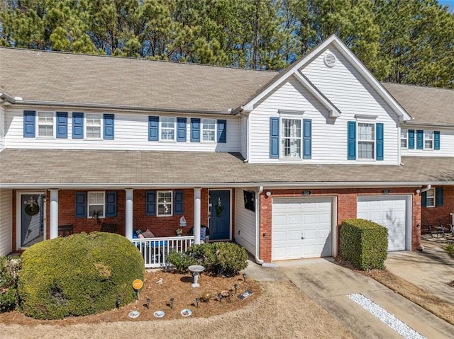 view of front of property featuring covered porch, concrete driveway, brick siding, and an attached garage