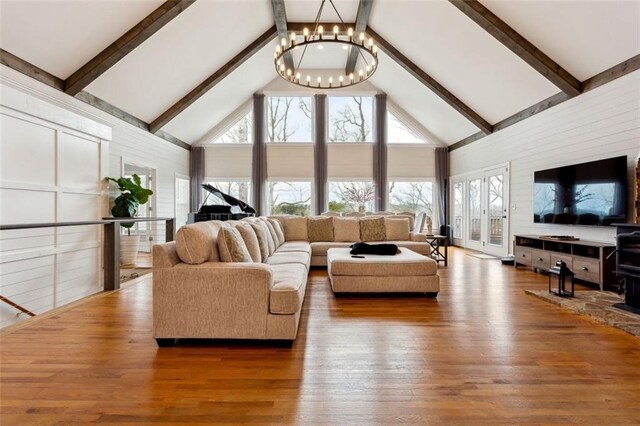 2600 Ramsey Rd, Gainesville, GA 30501 - living room featuring a notable chandelier, beam ceiling, hardwood / wood-style floors, and high vaulted ceiling