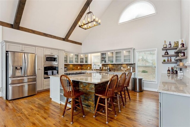 2600 Ramsey Rd, Gainesville, GA 30501 - dining area with an inviting chandelier, high vaulted ceiling, beam ceiling, and light hardwood / wood-style floors