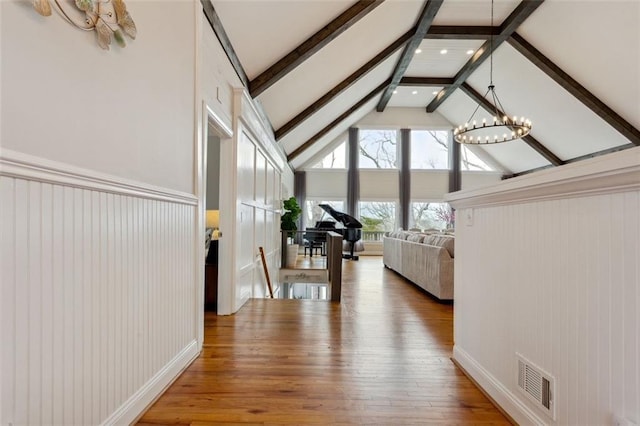 2600 Ramsey Rd, Gainesville, GA 30501 - interior space featuring beamed ceiling, high vaulted ceiling, hardwood / wood-style flooring, and an inviting chandelier