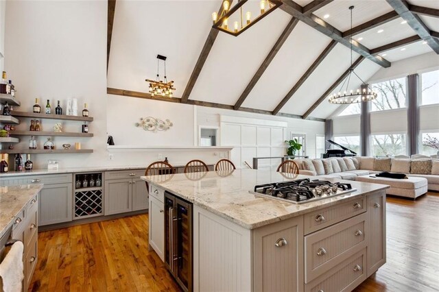 2600 Ramsey Rd, Gainesville, GA 30501 - kitchen featuring wine cooler, stainless steel gas cooktop, an inviting chandelier, decorative light fixtures, and gray cabinets
