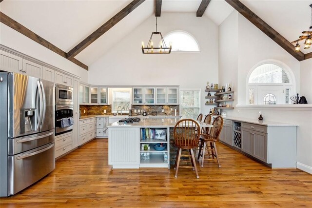 2600 Ramsey Rd, Gainesville, GA 30501 - kitchen featuring appliances with stainless steel finishes, decorative light fixtures, gray cabinets, and a kitchen island