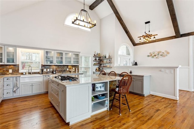 2600 Ramsey Rd, Gainesville, GA 30501 - kitchen featuring a kitchen island, gray cabinetry, a chandelier, and decorative light fixtures
