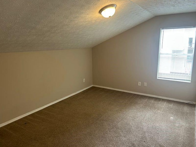 4963 Windsor Downs Ln, Decatur, GA 30035 - additional living space featuring dark carpet, a textured ceiling, lofted ceiling, and baseboards