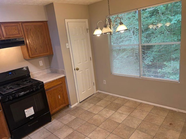 4963 Windsor Downs Ln, Decatur, GA 30035 - kitchen with black gas stove, range hood, light countertops, and brown cabinetry