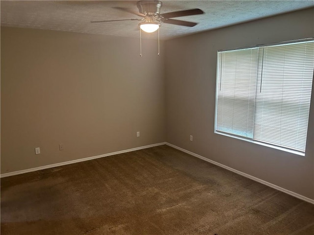 4963 Windsor Downs Ln, Decatur, GA 30035 - spare room featuring a ceiling fan, dark carpet, a textured ceiling, and baseboards