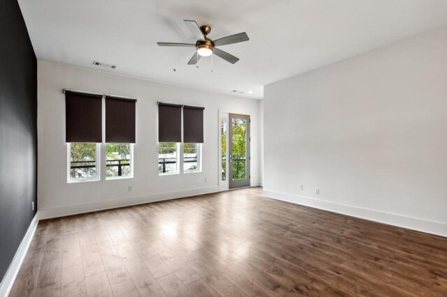 unfurnished room with ceiling fan and wood-type flooring