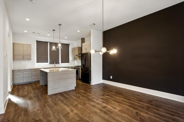 kitchen with a center island, black refrigerator with ice dispenser, dark hardwood / wood-style floors, tasteful backsplash, and decorative light fixtures