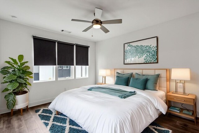 bedroom featuring ceiling fan and dark wood-type flooring