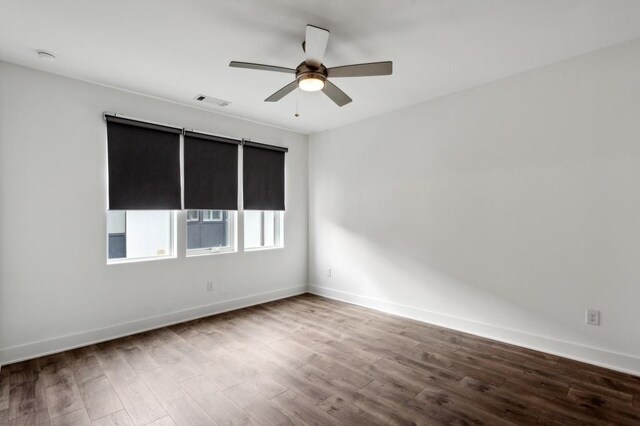 empty room featuring hardwood / wood-style floors and ceiling fan