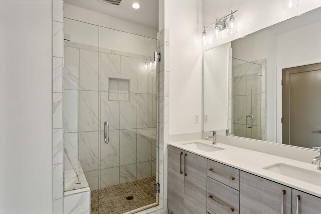 bathroom with vanity and a shower with shower door