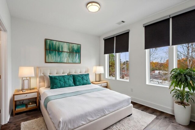 bedroom with dark wood-type flooring