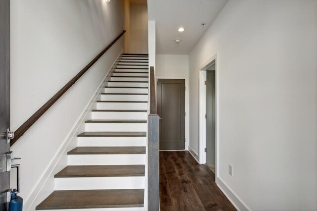 staircase featuring wood-type flooring