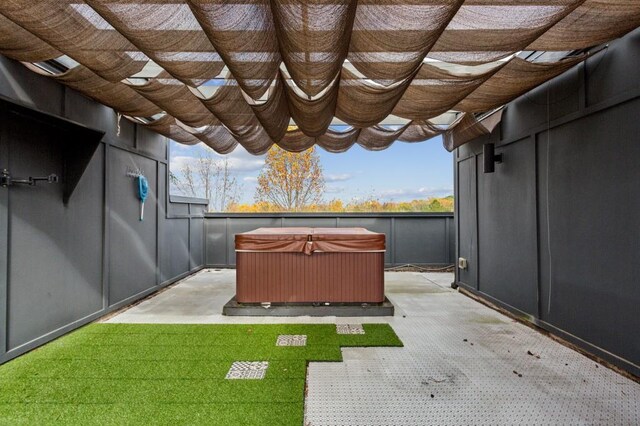 exterior space with a patio, a pergola, and a hot tub