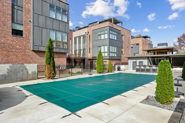 view of swimming pool with exterior bar