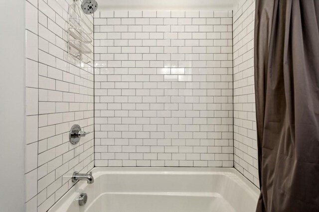 bathroom with shower / bathtub combination with curtain