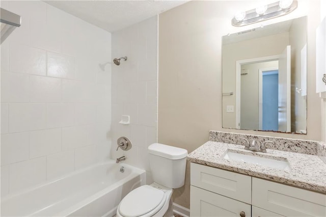 bathroom with toilet,  shower combination, and vanity