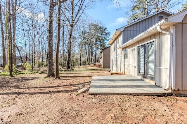 view of yard with french doors and a patio