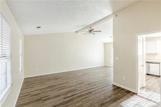 unfurnished living room featuring visible vents, lofted ceiling with beams, wood finished floors, baseboards, and ceiling fan