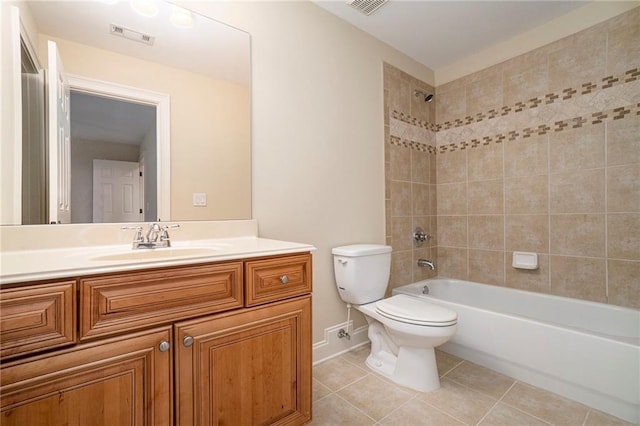 full bathroom featuring tile patterned flooring, vanity, tiled shower / bath combo, and toilet