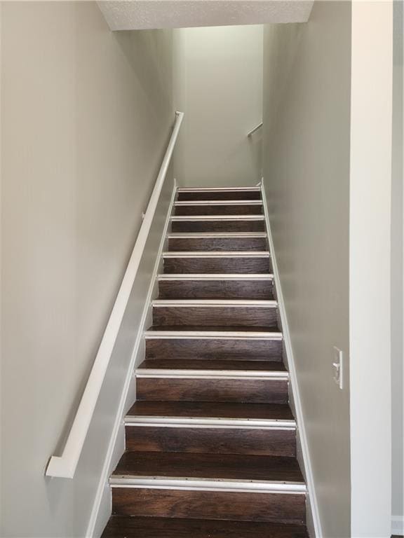 stairs featuring wood finished floors