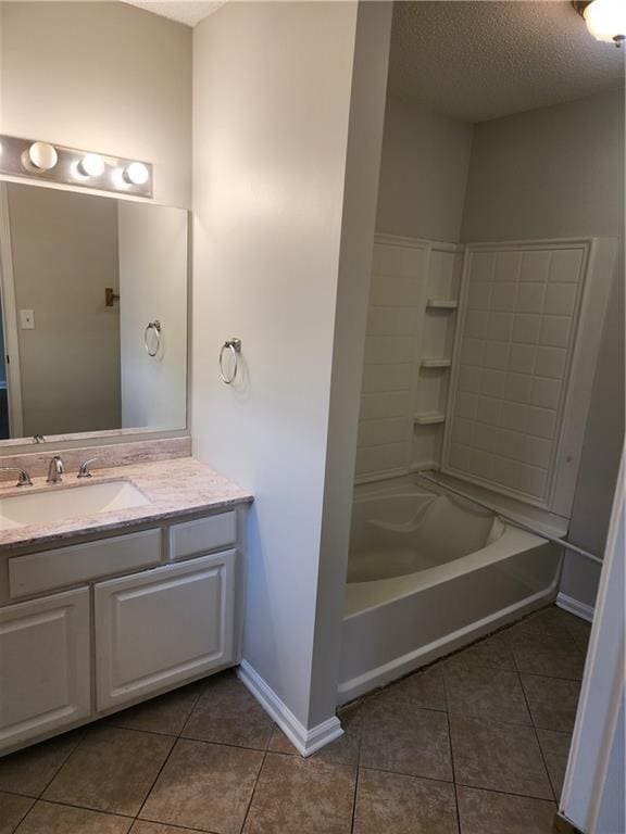 empty room featuring dark wood-style floors, a textured ceiling, baseboards, and a ceiling fan