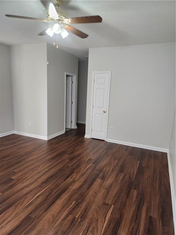 unfurnished room with stairs, dark wood-style floors, baseboards, and a ceiling fan