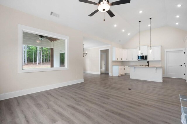 150 Doris Path, Dallas, GA 30157 - unfurnished living room featuring a ceiling fan, wood finished floors, recessed lighting, baseboards, and high vaulted ceiling