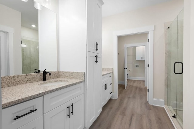 150 Doris Path, Dallas, GA 30157 - full bath with a stall shower, wood finished floors, vanity, baseboards, and recessed lighting