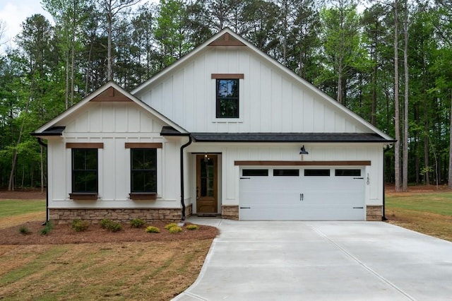 150 Doris Path, Dallas, GA 30157 - modern inspired farmhouse featuring concrete driveway, board and batten siding, and a garage