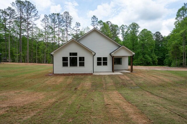 150 Doris Path, Dallas, GA 30157 - back of house with a lawn and a view of trees