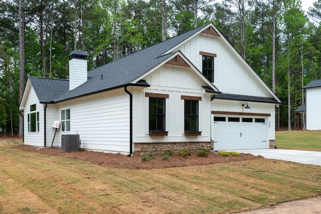 150 Doris Path, Dallas, GA 30157 - modern farmhouse featuring roof with shingles, concrete driveway, a garage, a front lawn, and a chimney